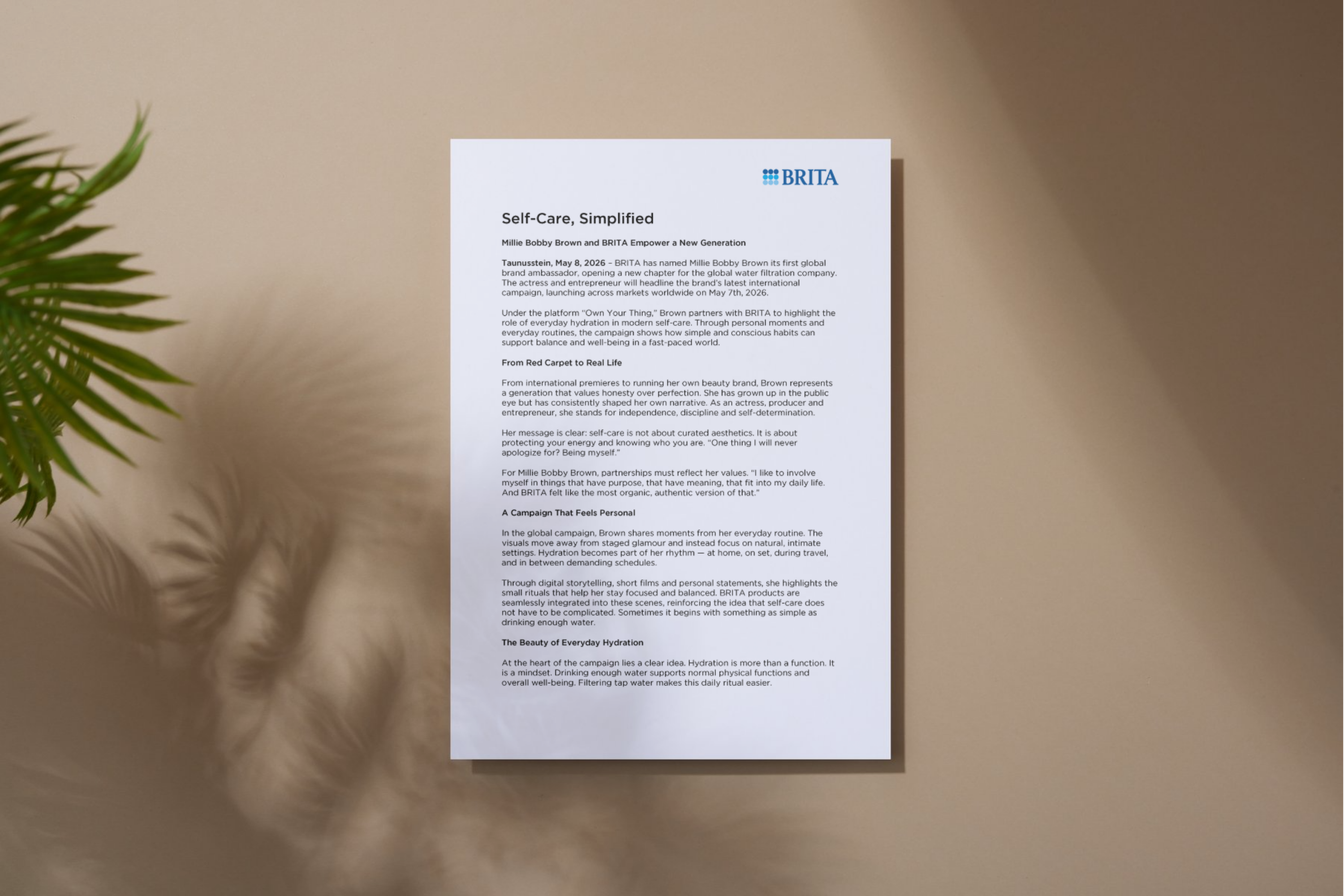 Document with a press release, with a blurred plant in the foreground on the left.
