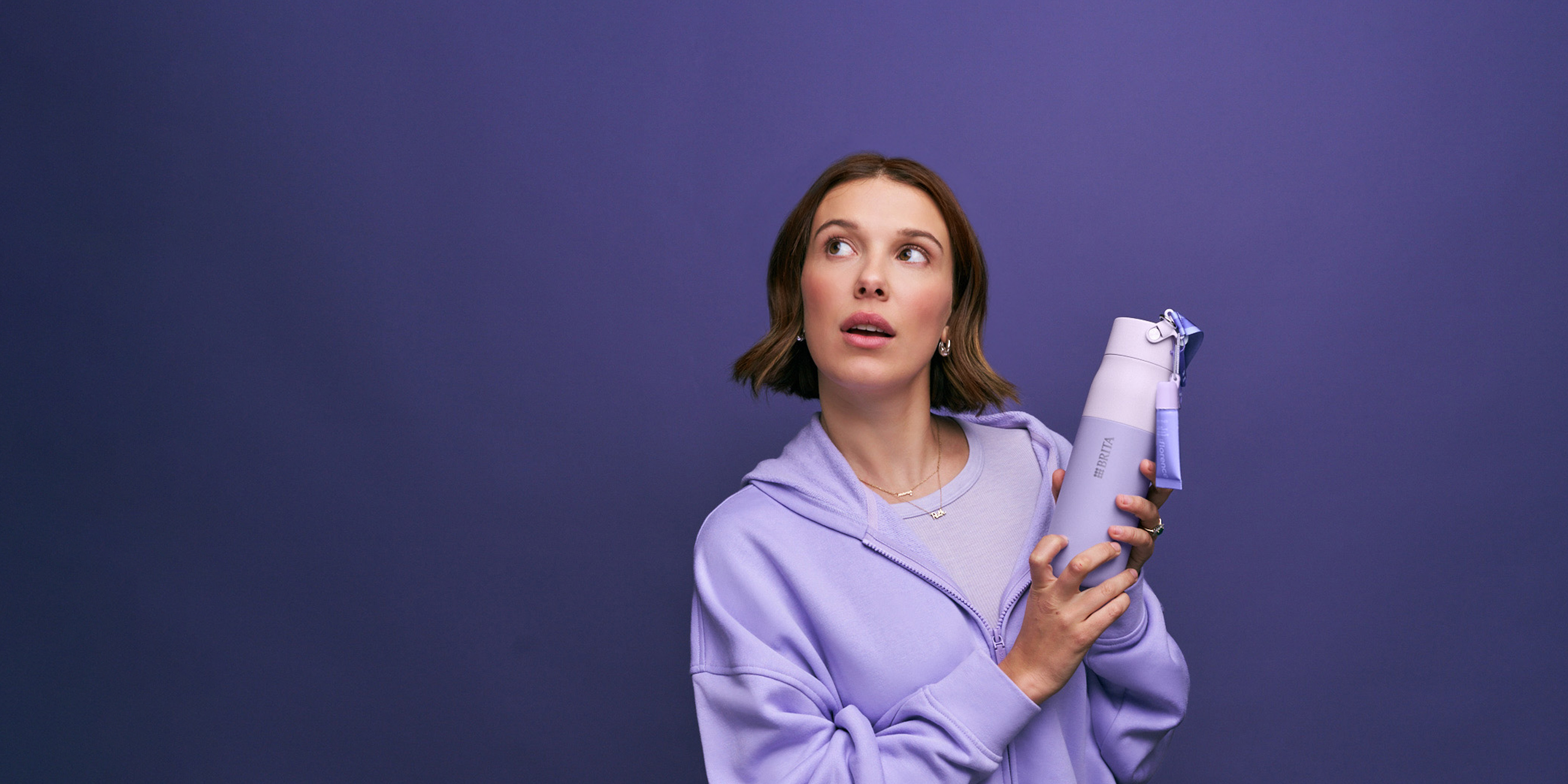 Millie Bobby Brown in lila Sweatshirt hält florence by mills x BRITA LARQ Flasche