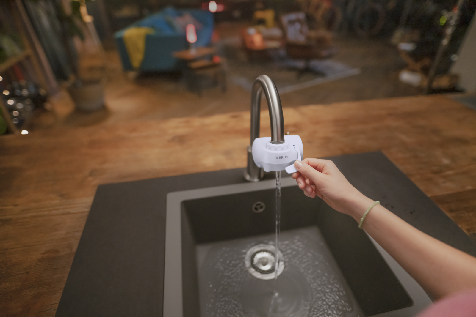 Frau benutzt den BRITA ON TAP V Eine Frau benutzt den BRITA ON TAP V in einer Küche