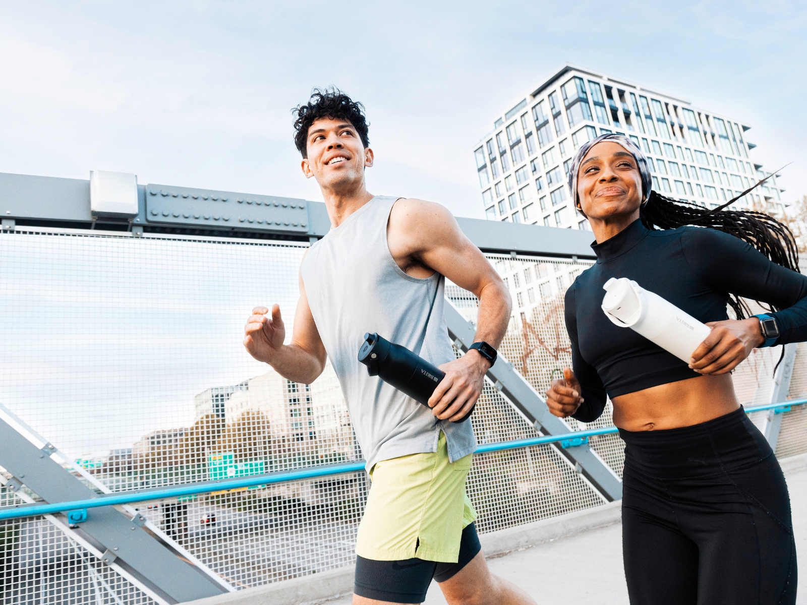 Eine Frau und ein Mann beim Joggen, in ihrer Hand halten sie die BRITA LARQ iQ Filter-Trinkflasche