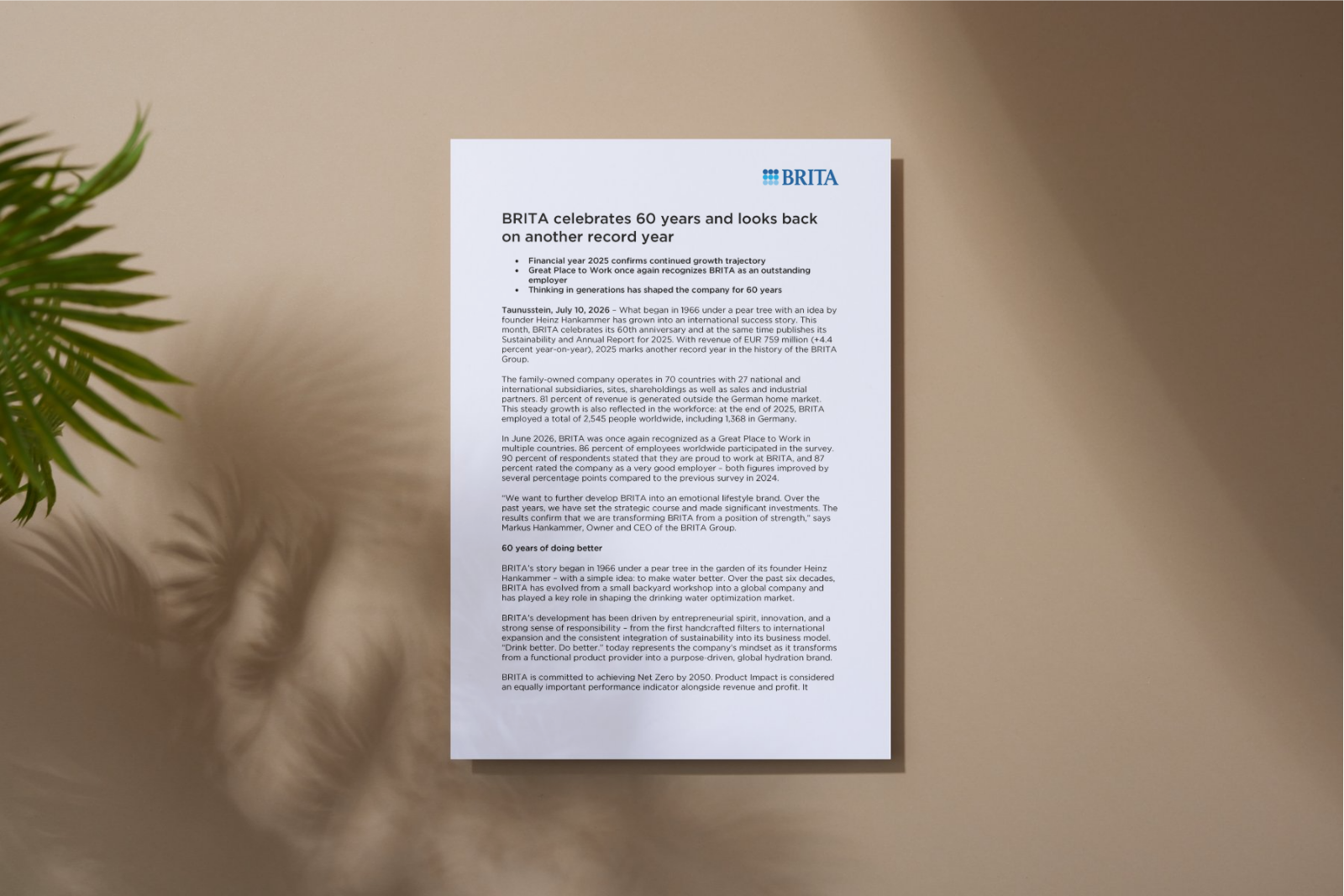 Document with a press release, with a blurred plant in the foreground on the left.