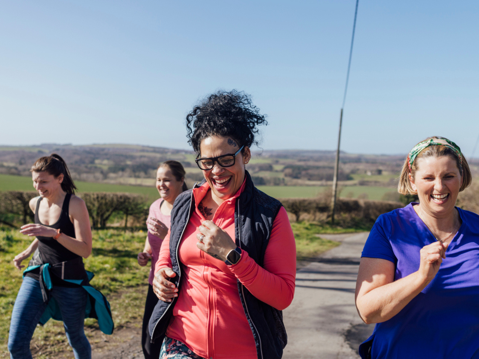 Outdoor-Kleidung Vier Joggerinnen in atmungsaktiver Kleidung