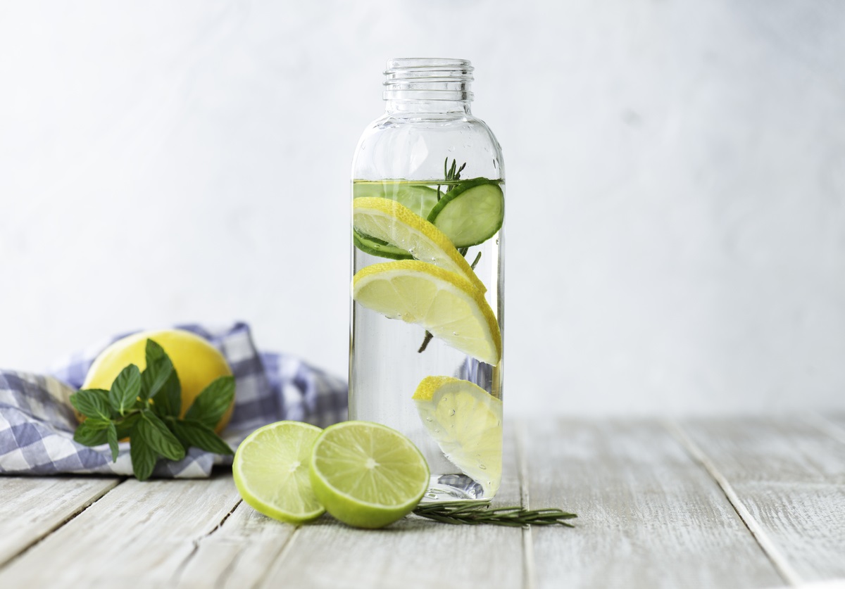 Detox Wasser: Infused Detox-Wasser mit Zitrone Glasgefäß mit von BRITA gefiltertem Wasser, Minze, Gurken- und Zitronenscheiben auf einem Holztisch